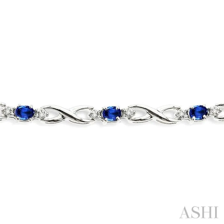 4x3mm Oval Cut Sapphire and 1/10 Ctw Single Cut Diamond Bracelet in 10K White Gold