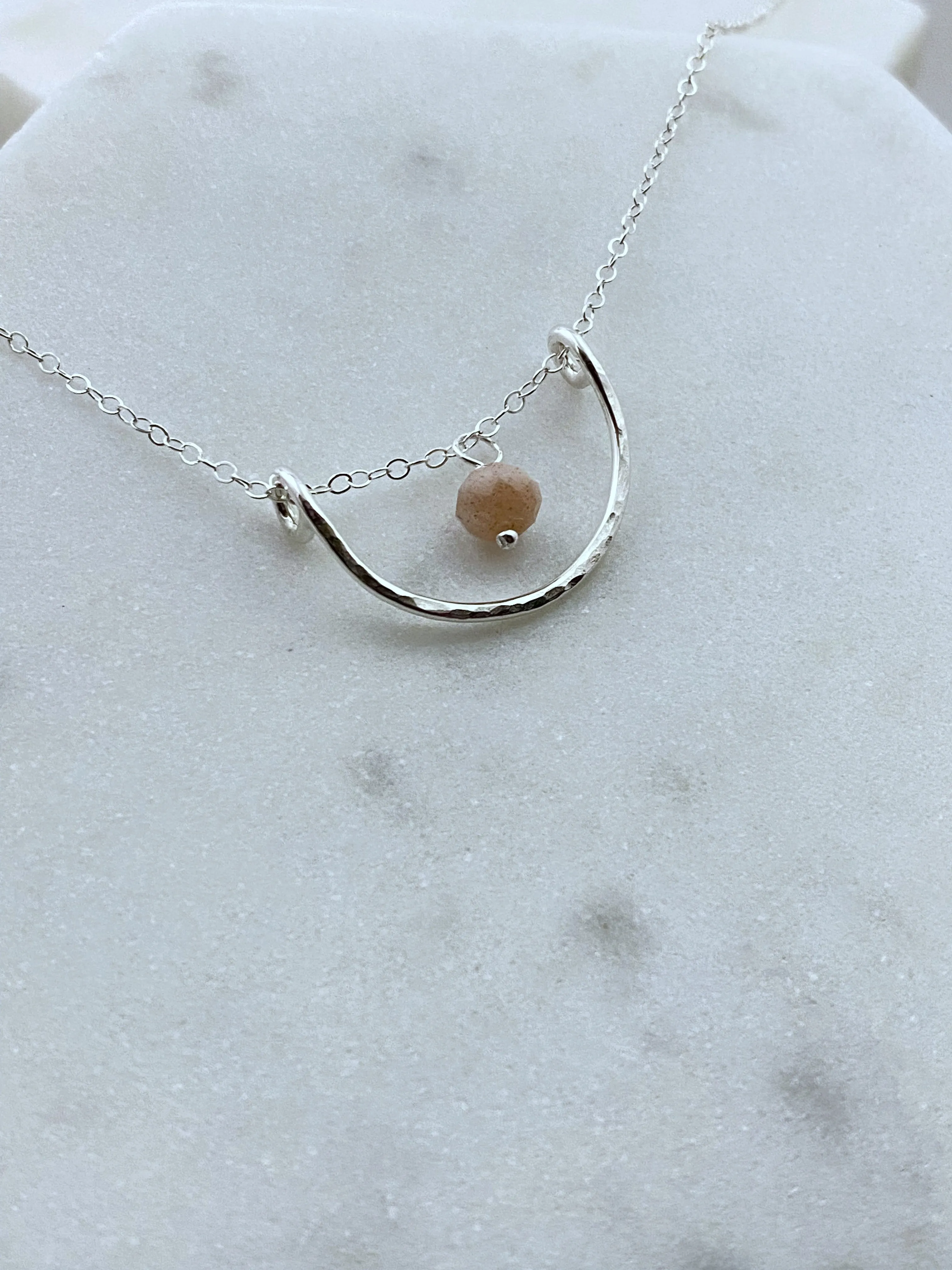 Forged sterling silver wire half moon necklace with peach moonstone