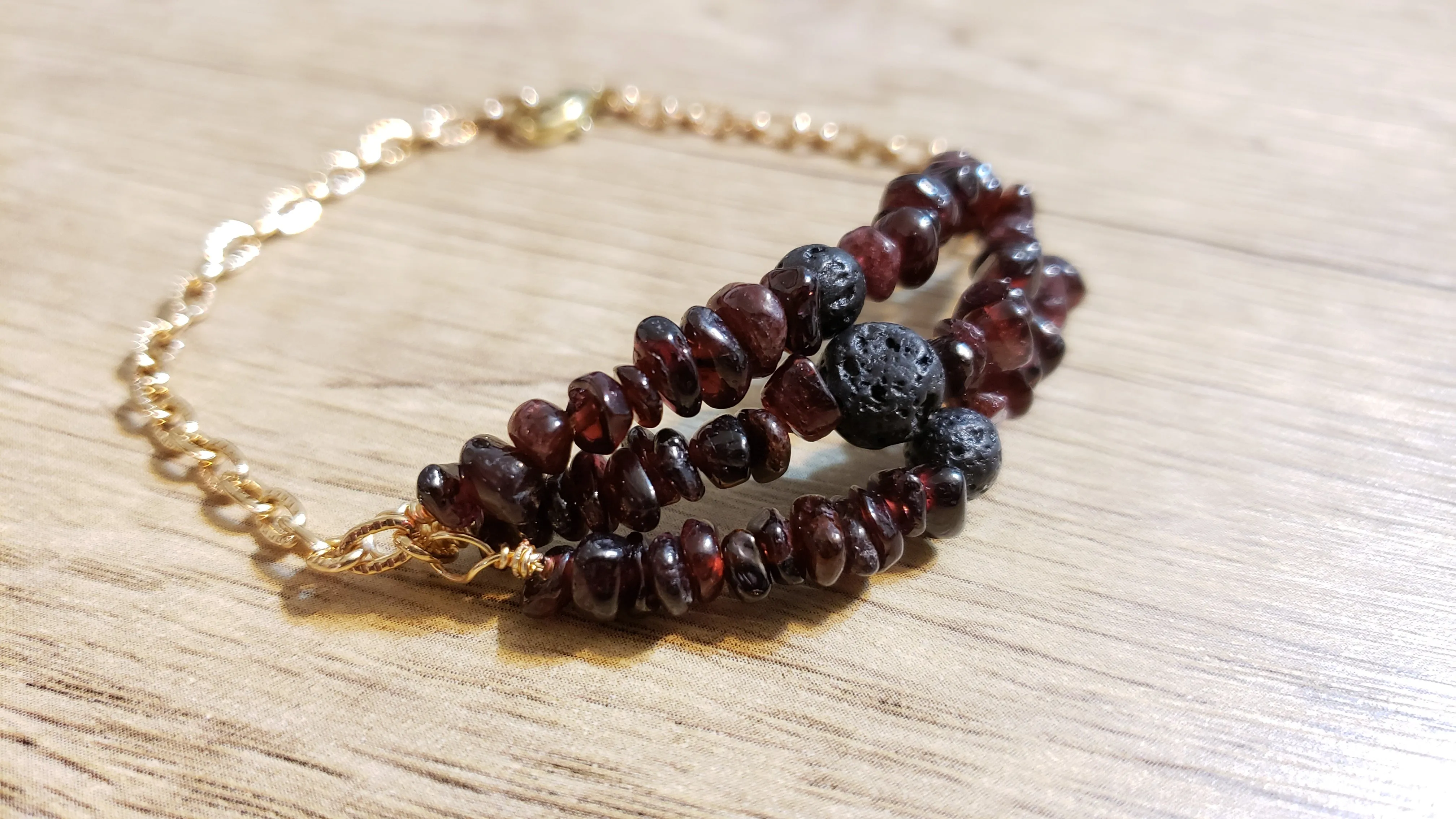 Hand Crafted All Natural, Triple Strand Garnet Gemstone & Gold Tone Chain Bracelet with Lava Rocks. Non Tarnish & Fully Adjustable to 8.5" with Lobster Claw Clasp